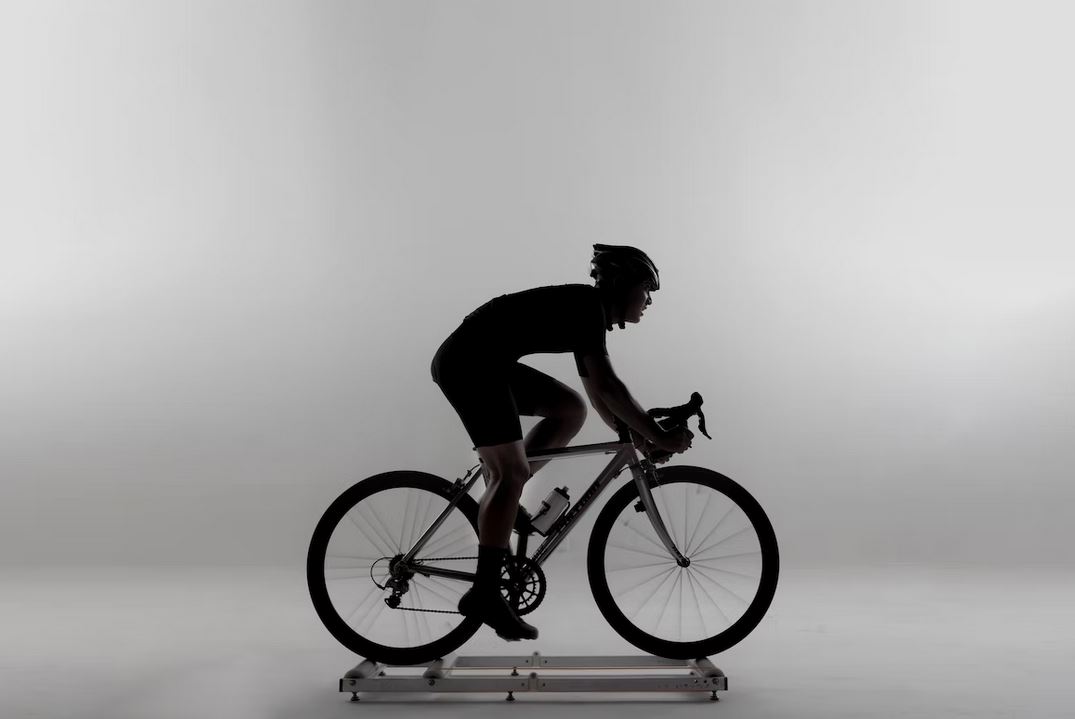 un cycliste qui sentraine sur un hometrainer sur son velo de course